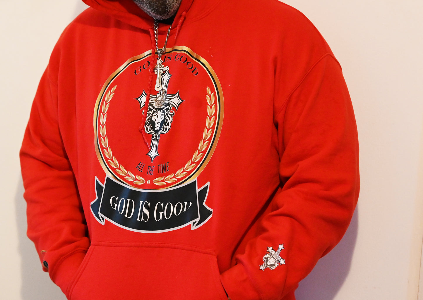 Red hoodie with graphic design and text on a plain background