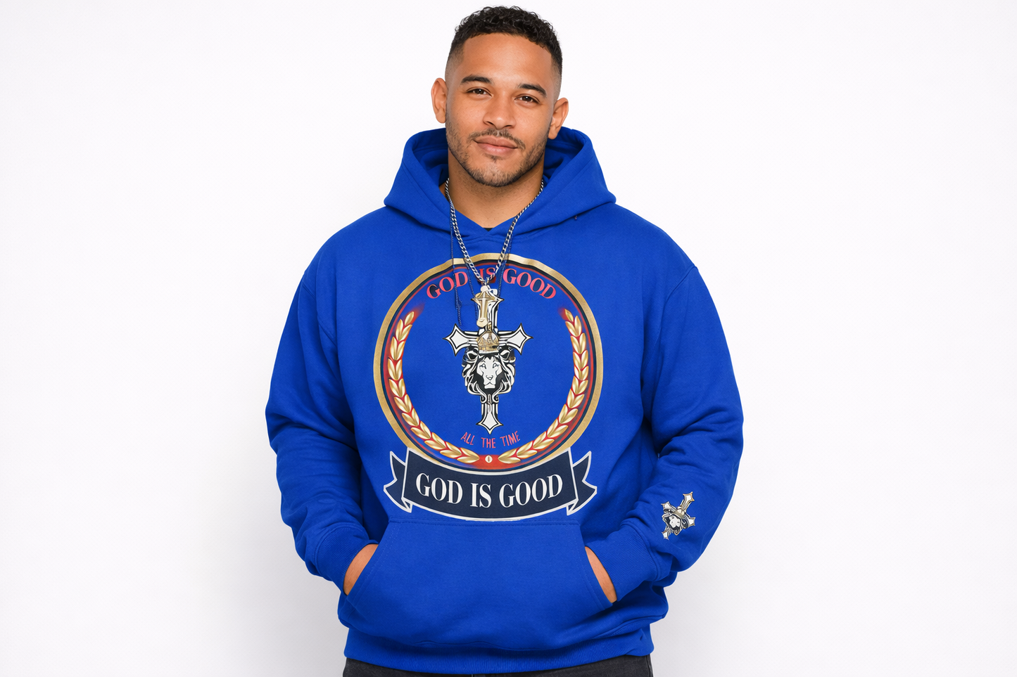 Man wearing a blue hoodie with 'God is Good' design on a white background