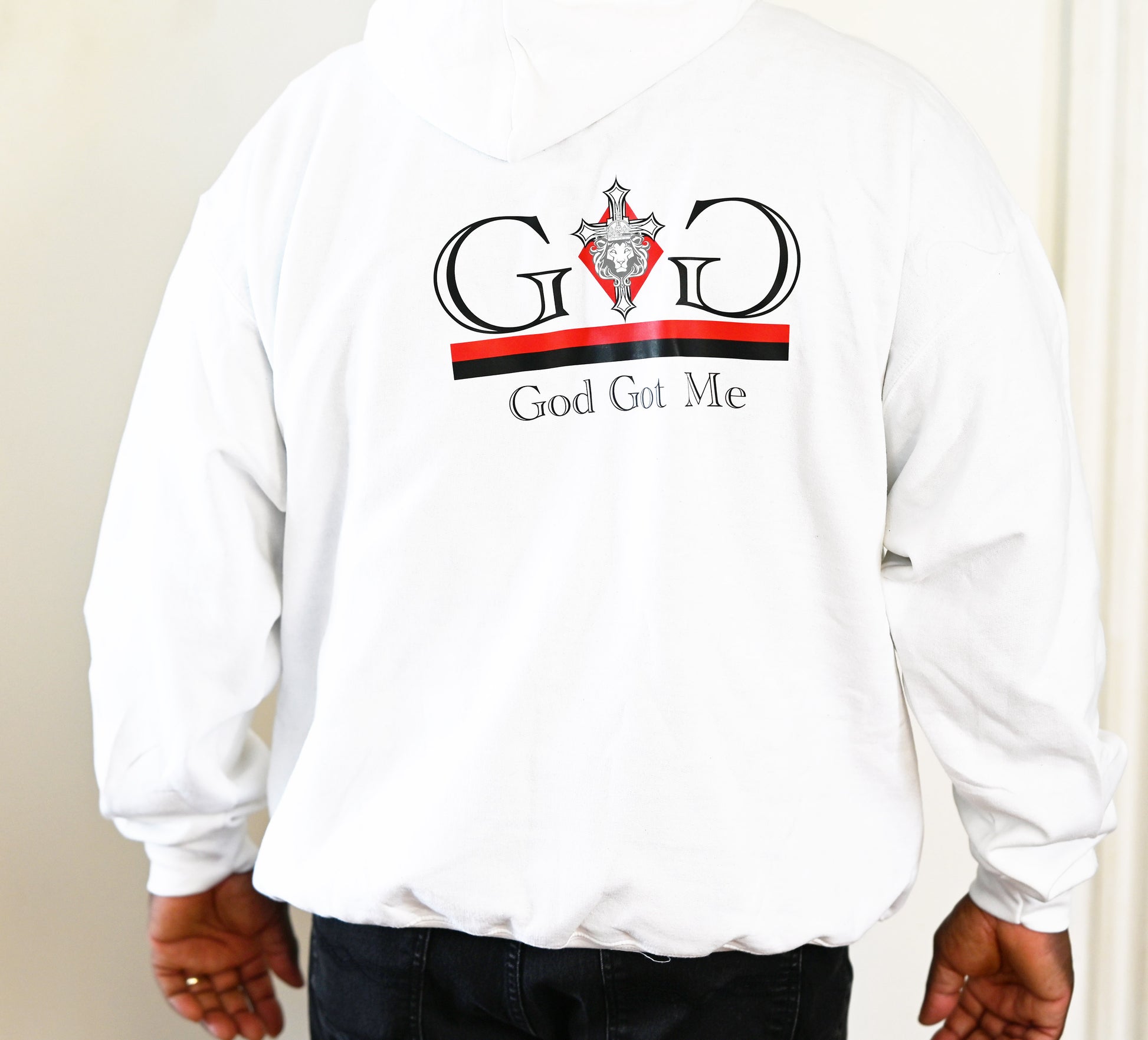 White sweatshirt with 'God Got Me' text and logo on a plain background