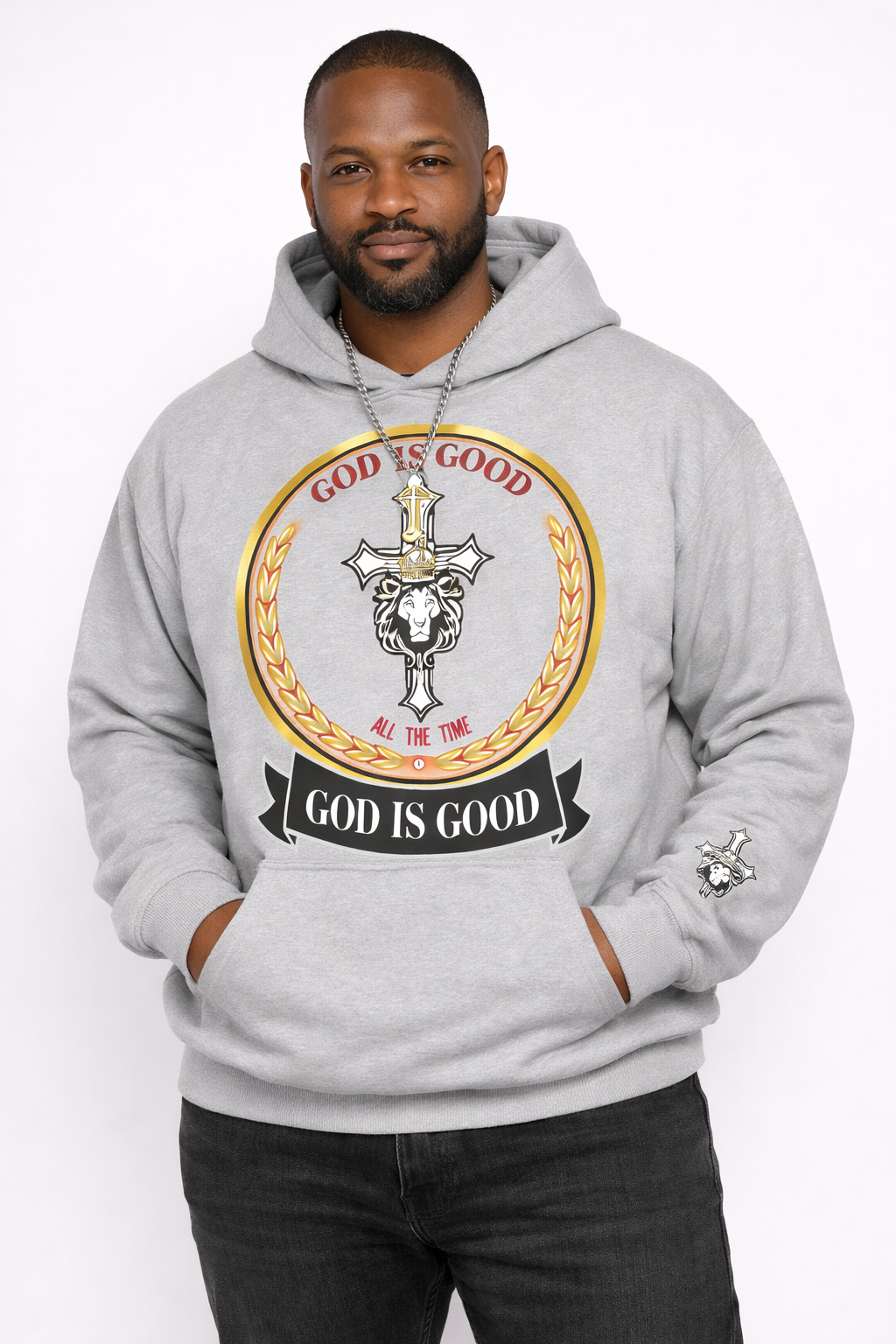 Man wearing a gray hoodie with 'God is Good' graphic design on a white background