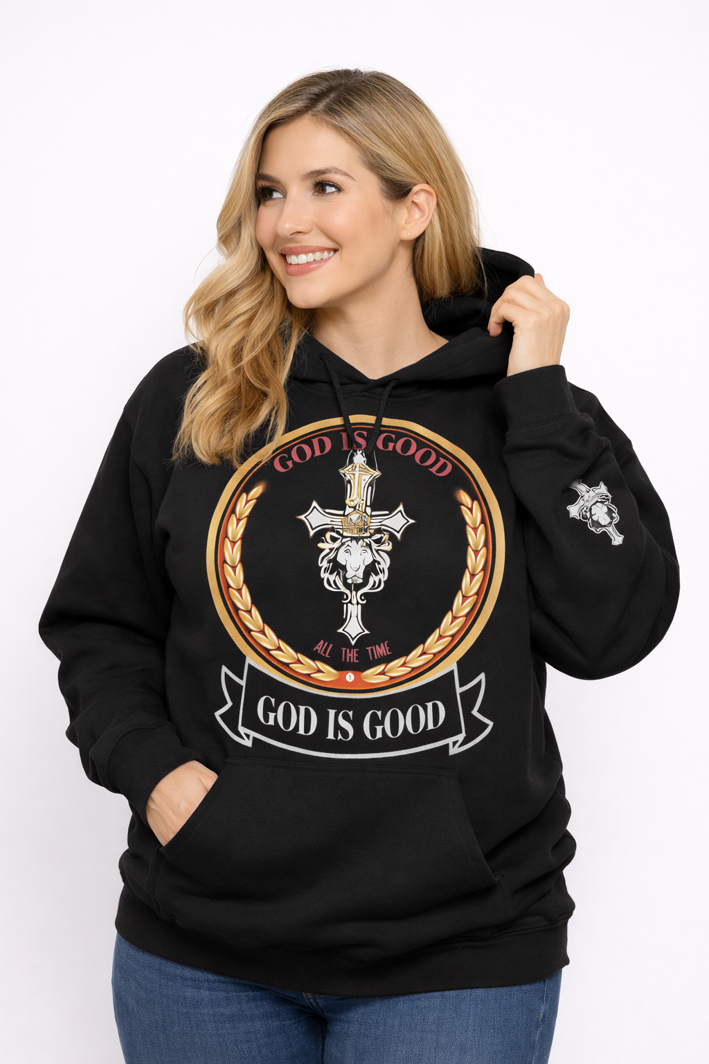 Woman wearing a black hoodie with 'God is Good' graphic design on a white background