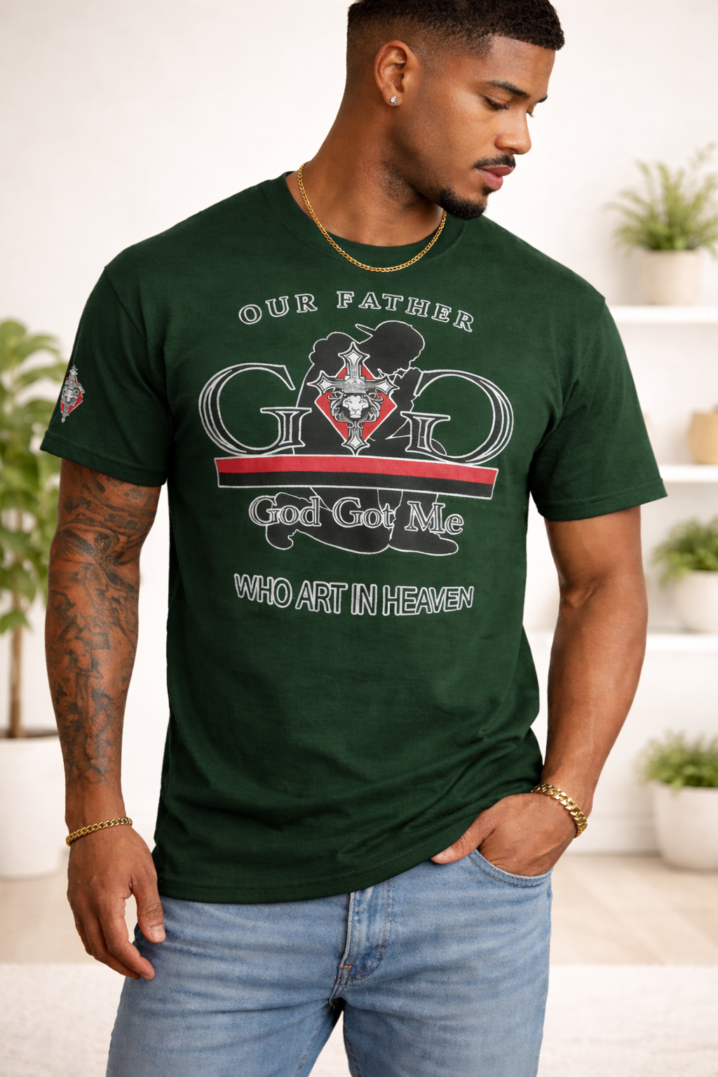 Man wearing a green t-shirt with a graphic design and text, standing in a room with plants.