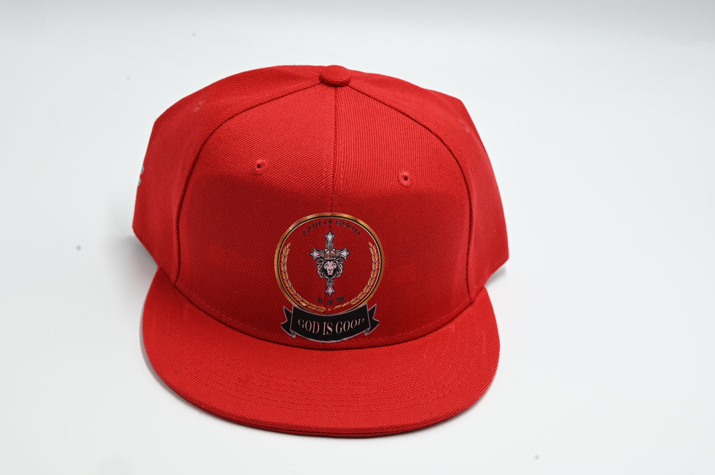 Red cap with a logo and text on a white background 