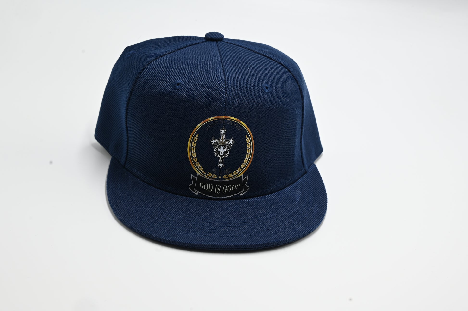 Navy blue cap with gold emblem on a white background